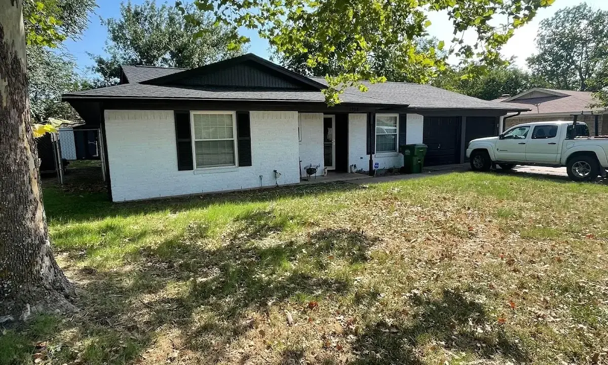Professional roofing crew working on a residential roof in Lakeland Village